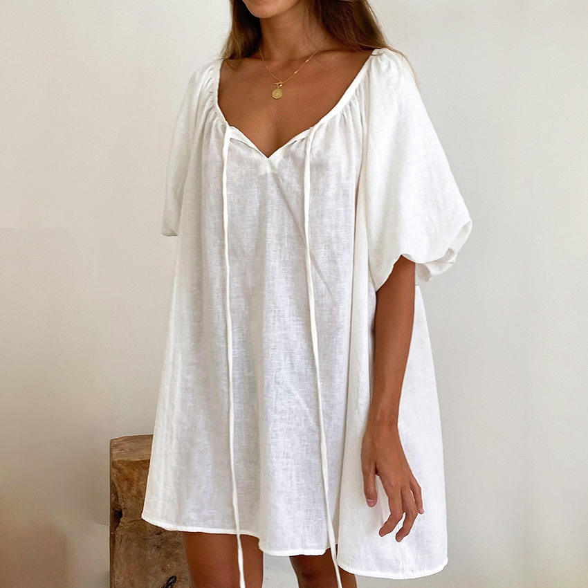 Woman wearing white short robe dress with three-quarter sleeves