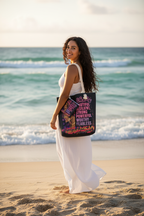 Latina woman standing on sunny beach holding She is Beautiful Resilient Strong canvas tote bag – empowering beach lifestyle photo